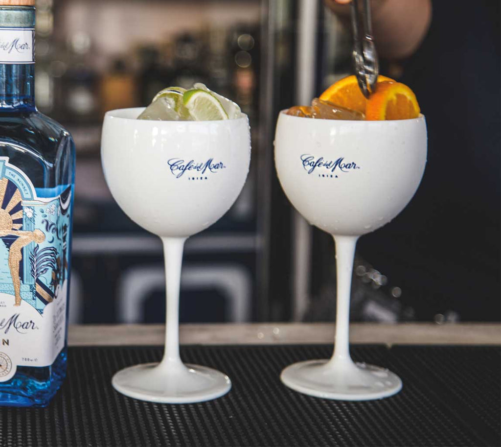 Two branded Café del Mar balloon glasses containing exotic cocktails